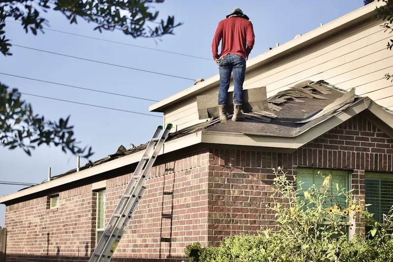 Professional roofer working on a residential roof in Gas City